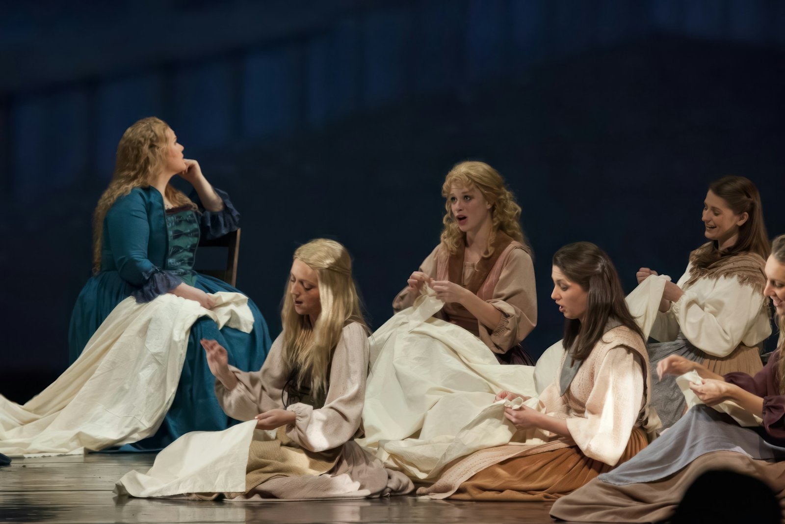 Opera singers performing on stage representing different opera voice types.